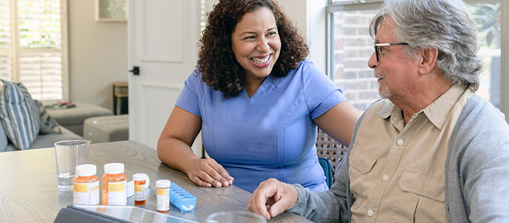Caregiver greeting a senior client with a smile